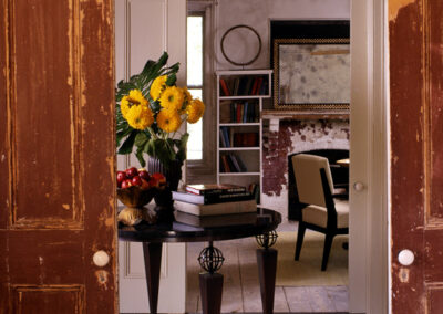 Rustic Elegant entryway table with bright yellow floral arrangement overlooking the living room